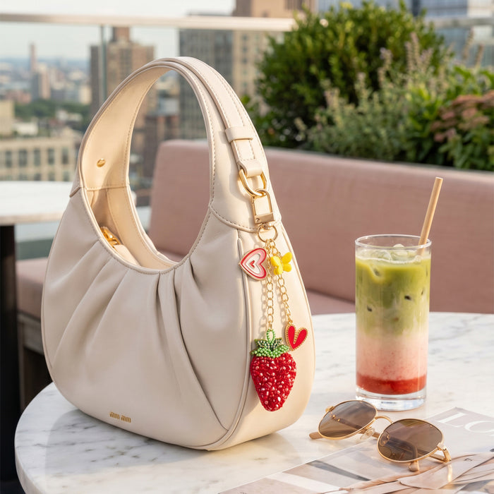 Sweetberry Squad bag charm with embroidered strawberry, heart charms and butterfly accent