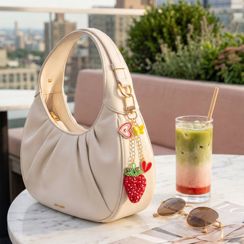Sweetberry Squad bag charm with embroidered strawberry, heart charms and butterfly accent