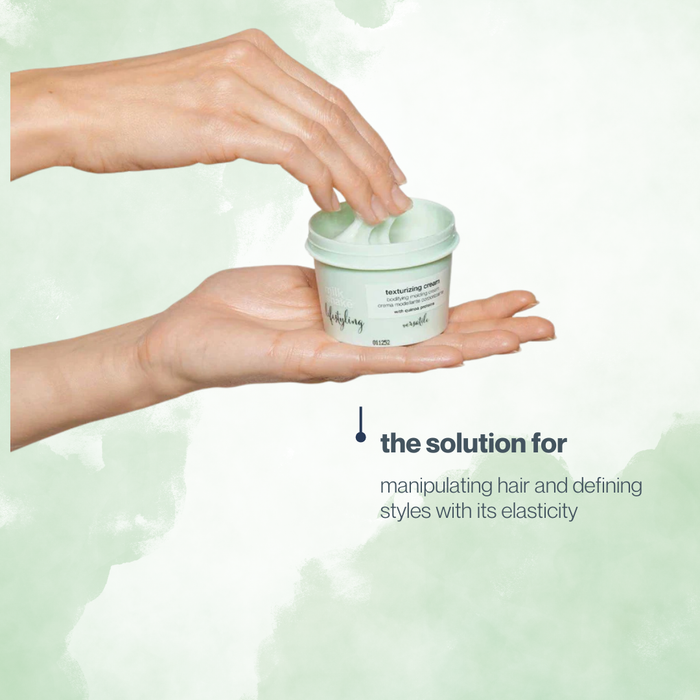 Hand holding a container of milk_shake  hair product with text about its elasticity benefits on a light green background
