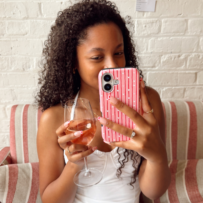 Girl with wine in hand taking selfie with Love Drops Phone Case