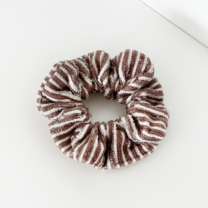Coconut Lane towel scrunchie with chestnut brown and white stripes on a white surface.