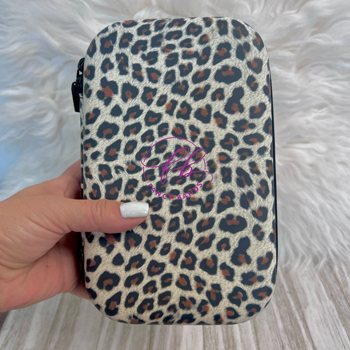 Travel Size Leopard Print Fancy Band Storage Case — Case made of PU leather, Nylon, Multi spandex, Lycra Dimensions are W 8 1/2" x L 5 1/2" x H 2 1/4" This item is storage case only bands not inclu...