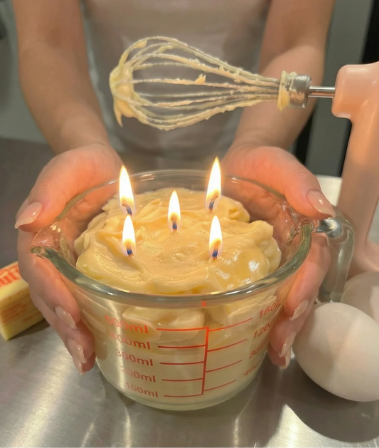 Realistic dessert-inspired candle with four flames in a measuring cup, kitchen setting