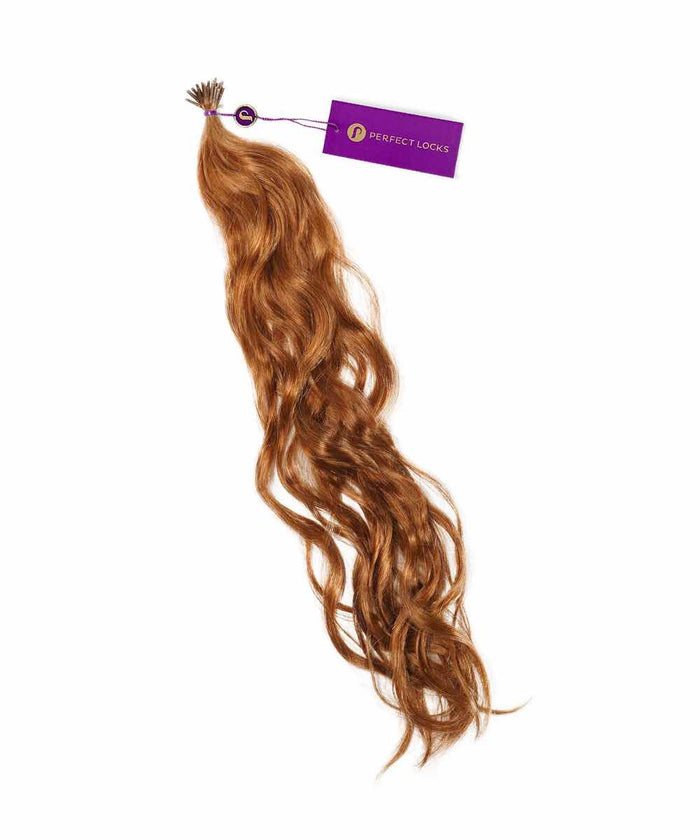 A bundle of long, wavy Golden Brown  Perfect Locks Wavy Fusion I-Tip Hair extensions, shiny and healthy, with a small purple tag near the top.#color_golden-brown-(6)