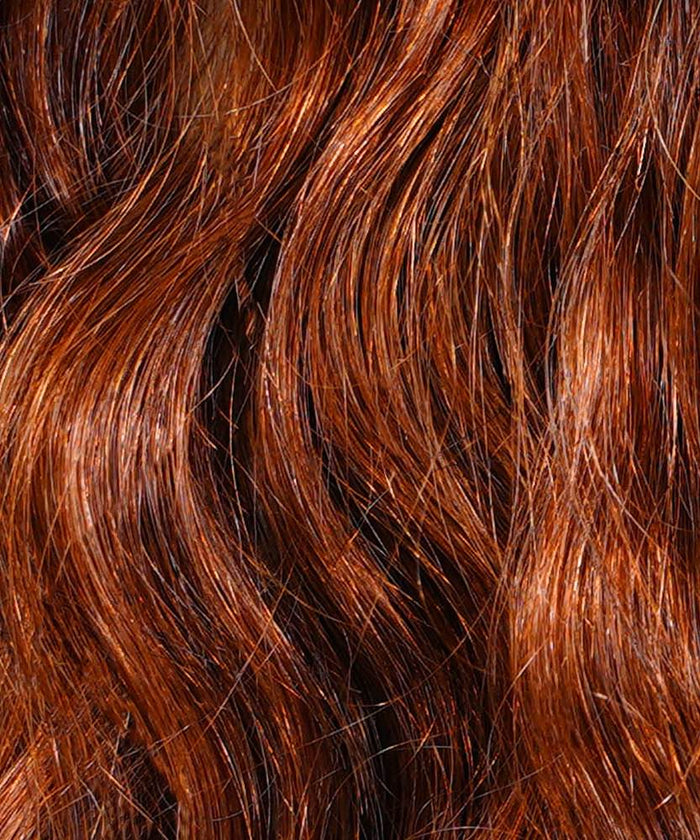 Close-up of wavy, shiny reddish-brown hair with rich tones and highlights, featuring Warm Mocha Lowlights (2/4/6) wefts.#color_dark-auburn-(33)